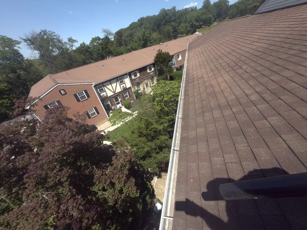 Commercial gutter cleaning on a multi-unit building roofline