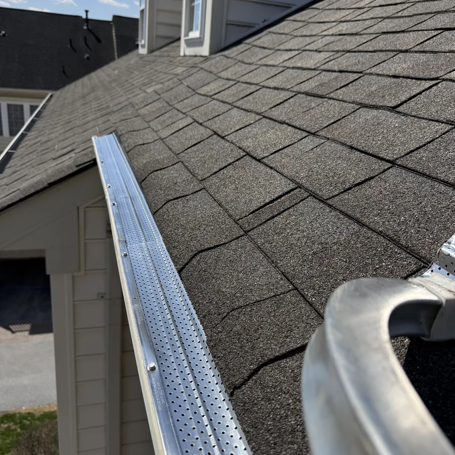 ClearFlow gutter guard installed on a steep shingle roofline